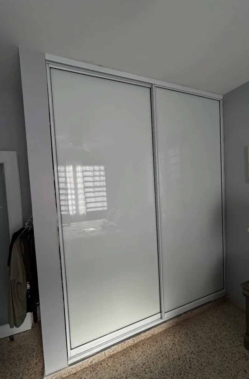 Después: closet con puertas corredizas de cristal blanco
